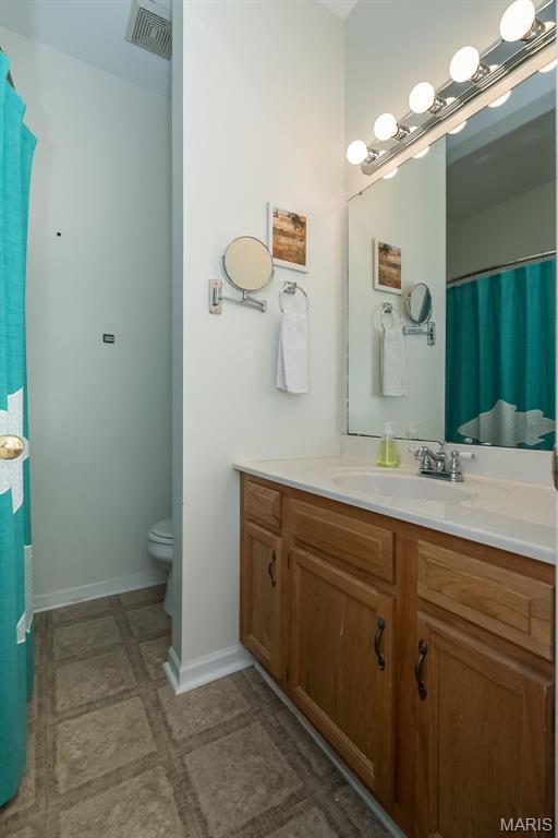 1003 Allen Ave, Saint Louis, MO 63104 - bathroom with toilet, vanity, and baseboards