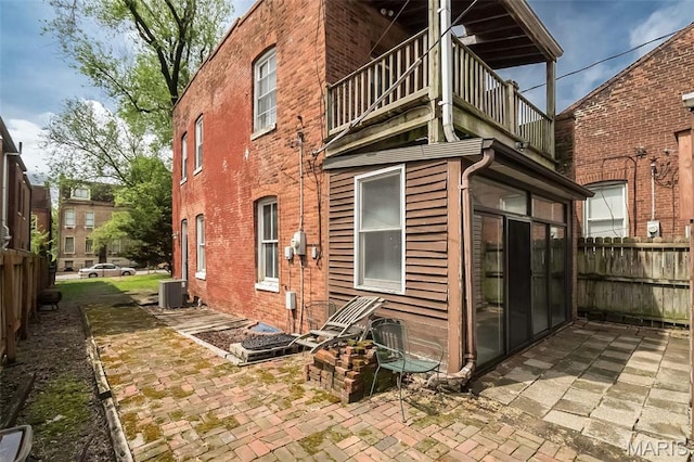 1003 Allen Ave, Saint Louis, MO 63104 - back of house with a balcony, fence, brick siding, and a patio