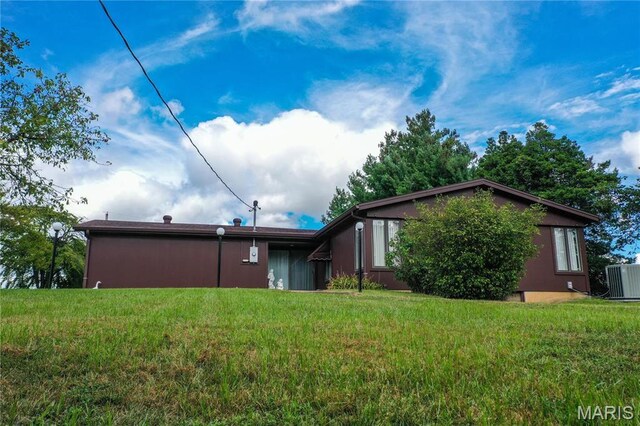 1500 Gravois Rd, High Ridge, MO 63049 - back of property featuring a lawn and central AC unit