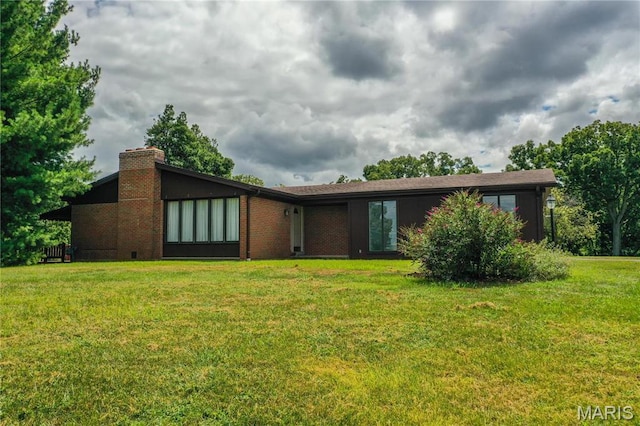 1500 Gravois Rd, High Ridge, MO 63049 - view of front facade with a chimney, a front yard, and brick siding