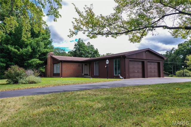 1500 Gravois Rd, High Ridge, MO 63049 - ranch-style house featuring asphalt driveway, an attached garage, a front lawn, a chimney, and brick siding