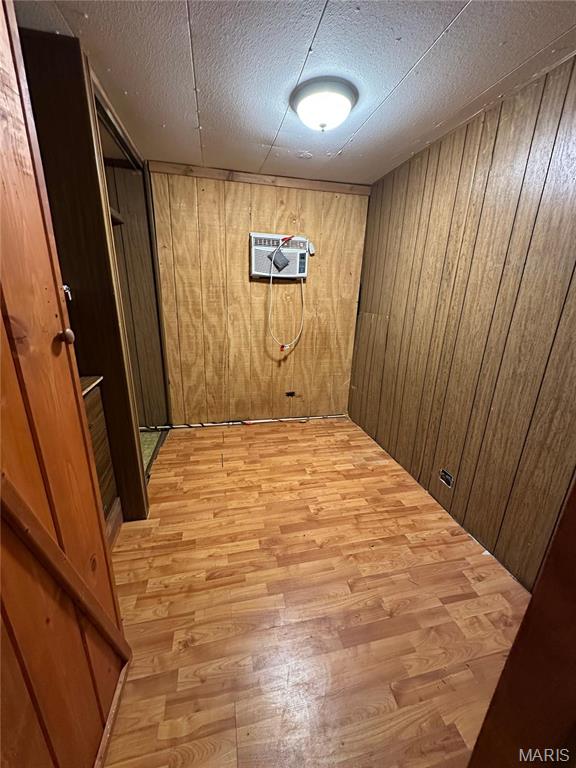 6209 Ripley 21 N-18, Doniphan, MO 63935 - finished below grade area featuring a wall mounted AC, light wood-style floors, wood walls, and a textured ceiling