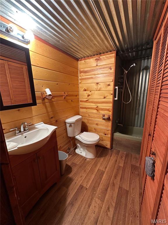6209 Ripley 21 N-18, Doniphan, MO 63935 - bathroom with toilet, vanity, wood finished floors, and wood walls