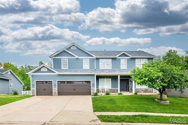 904 Indian Rock Ct, Wentzville, MO 63385 - view of front of home featuring a front yard, driveway, stone siding, and an attached garage