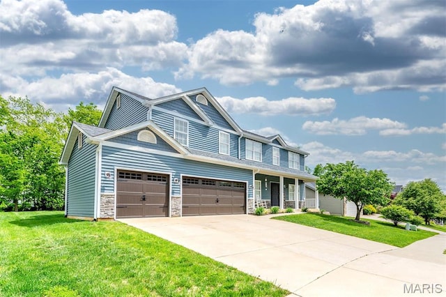 904 Indian Rock Ct, Wentzville, MO 63385 - view of front of house featuring a front yard, driveway, stone siding, and a garage