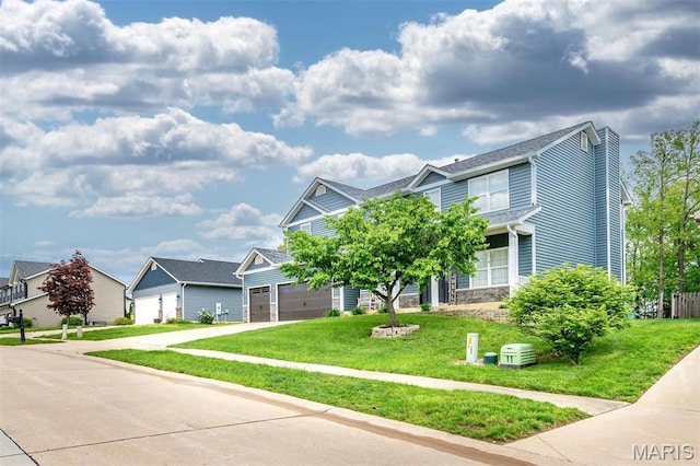 904 Indian Rock Ct, Wentzville, MO 63385 - view of front of house with concrete driveway, a front yard, a chimney, and a garage