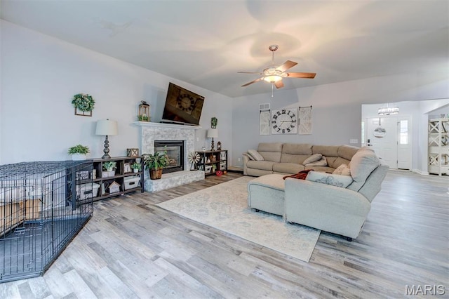 904 Indian Rock Ct, Wentzville, MO 63385 - living room with wood finished floors, ceiling fan, baseboards, and a glass covered fireplace
