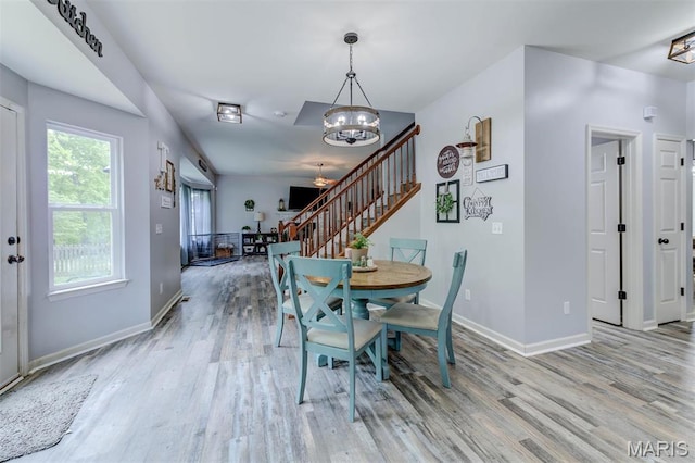 904 Indian Rock Ct, Wentzville, MO 63385 - dining space featuring a chandelier, stairway, light wood-style flooring, and baseboards
