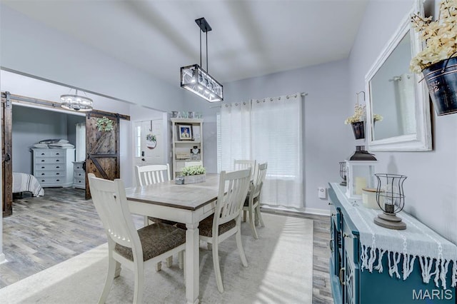 904 Indian Rock Ct, Wentzville, MO 63385 - dining space featuring a barn door and light wood-style flooring