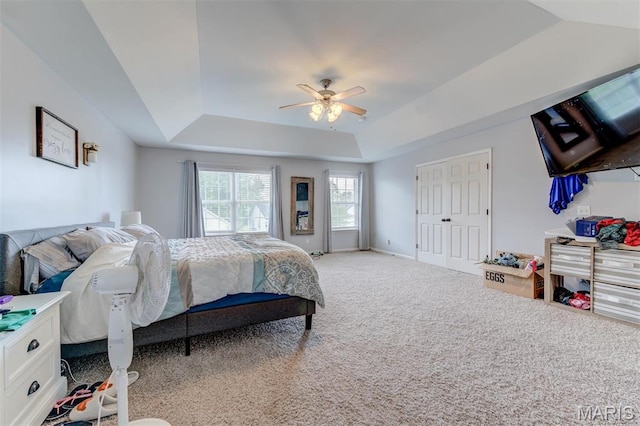904 Indian Rock Ct, Wentzville, MO 63385 - bedroom featuring a tray ceiling, light carpet, and ceiling fan