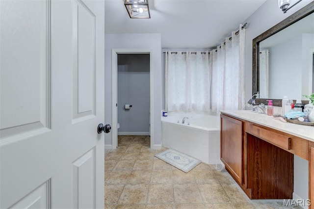 904 Indian Rock Ct, Wentzville, MO 63385 - bathroom featuring a bath, vanity, toilet, and baseboards