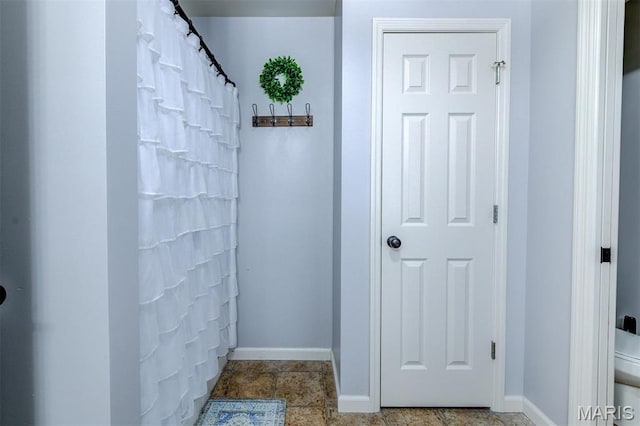 904 Indian Rock Ct, Wentzville, MO 63385 - bathroom featuring baseboards and a shower with shower curtain
