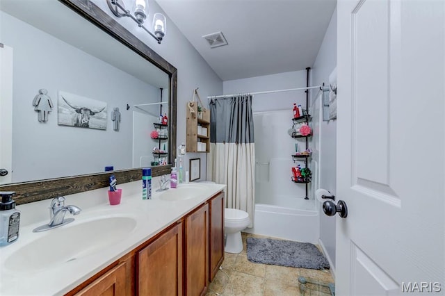 904 Indian Rock Ct, Wentzville, MO 63385 - bathroom featuring toilet, double vanity, shower / bath combination with curtain, and stone finish flooring