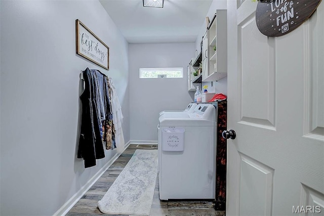 904 Indian Rock Ct, Wentzville, MO 63385 - washroom featuring independent washer and dryer, cabinet space, wood finished floors, and baseboards