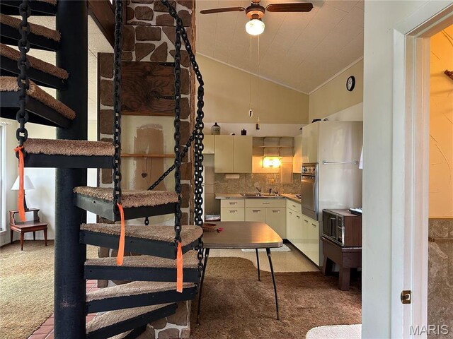 182 Ozark Dr, Ironton, MO 63650 - kitchen featuring crown molding, lofted ceiling, carpet, ceiling fan, and backsplash