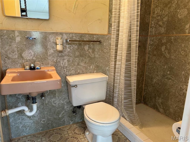 182 Ozark Dr, Ironton, MO 63650 - bathroom with toilet, a stall shower, tile patterned floors, a sink, and tile walls