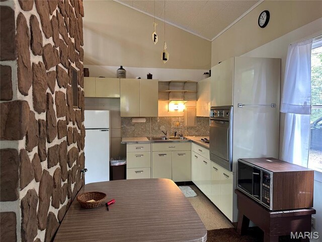 182 Ozark Dr, Ironton, MO 63650 - kitchen featuring crown molding, freestanding refrigerator, backsplash, a sink, and oven