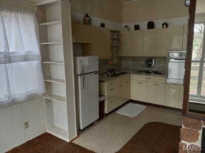182 Ozark Dr, Ironton, MO 63650 - kitchen with freestanding refrigerator, wall oven, open shelves, and healthy amount of natural light