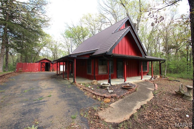 9434 Joan Ct, Bonne Terre, MO 63628 - view of side of property with board and batten siding, driveway, and a gate