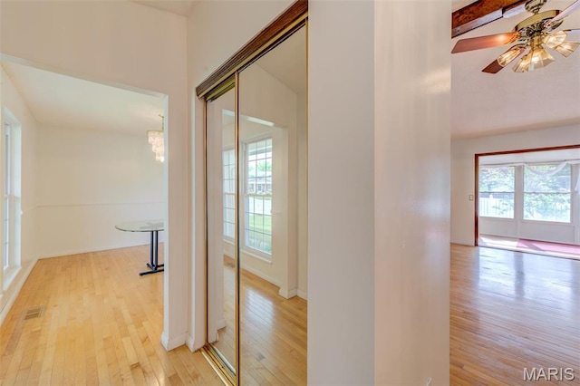 24 Shaw Ct, Cottleville Township, MO 63304 - hallway featuring light wood finished floors and a chandelier