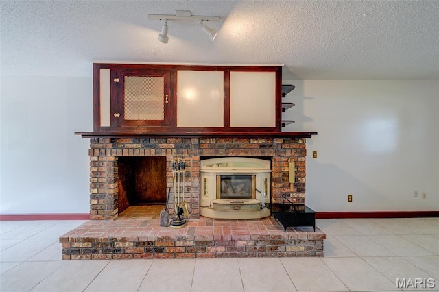 24 Shaw Ct, Cottleville Township, MO 63304 - unfurnished living room featuring a textured ceiling, rail lighting, baseboards, and tile patterned floors