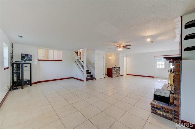 24 Shaw Ct, Cottleville Township, MO 63304 - unfurnished living room with stairway, a ceiling fan, baseboards, a wood stove, and light tile patterned flooring
