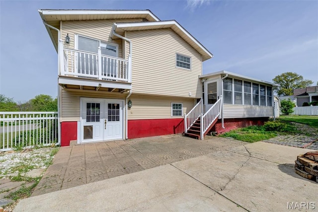 24 Shaw Ct, Cottleville Township, MO 63304 - rear view of property with a sunroom, a patio area, fence, and a balcony