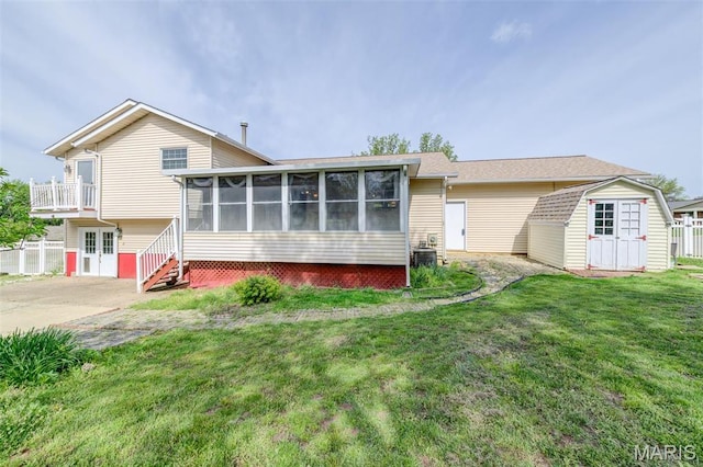 24 Shaw Ct, Cottleville Township, MO 63304 - view of front of property with a shed, a sunroom, an outdoor structure, and a front lawn