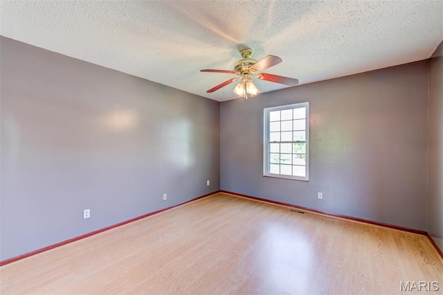 24 Shaw Ct, Cottleville Township, MO 63304 - unfurnished room featuring wood finished floors, ceiling fan, a textured ceiling, and baseboards