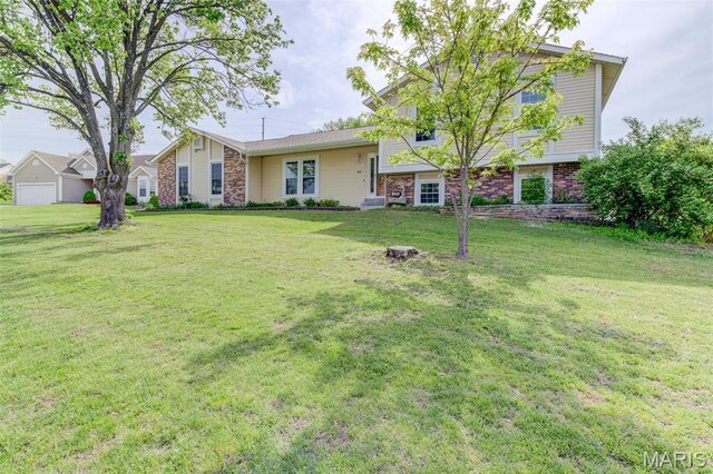 24 Shaw Ct, Cottleville Township, MO 63304 - back of property featuring a yard and brick siding