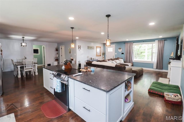 kitchen with stainless steel range with electric cooktop, open floor plan, white cabinets, recessed lighting, and a center island