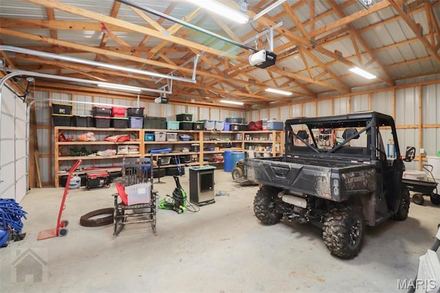 garage featuring a garage door opener and metal wall