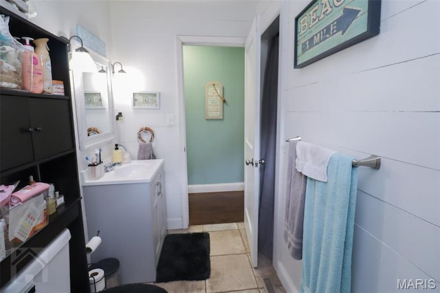 bathroom with vanity, tile patterned floors, and baseboards