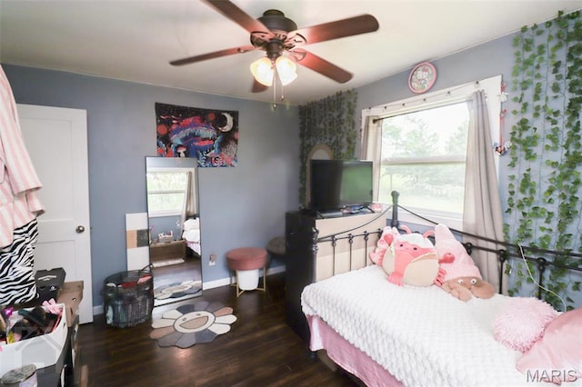 bedroom featuring wood finished floors, ceiling fan, and baseboards