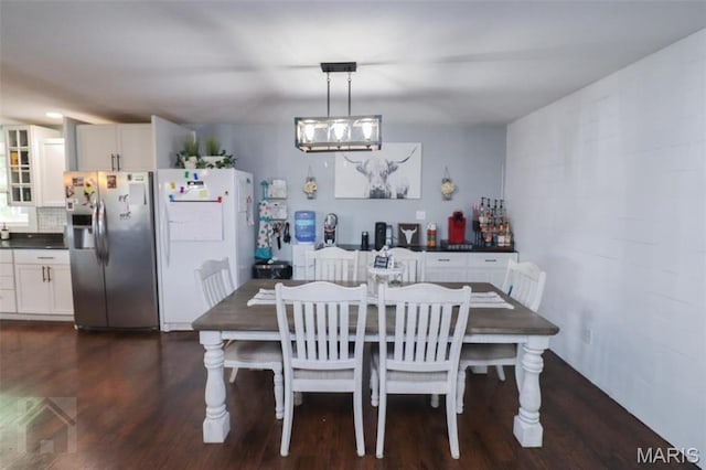 dining area featuring dark wood-style flooring