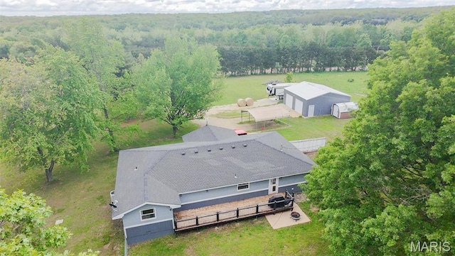view of subject property with a heavily wooded area