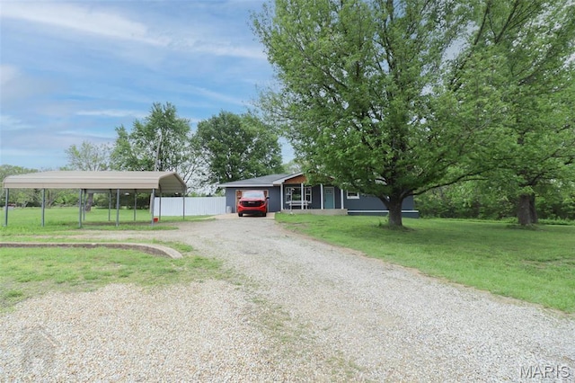 view of front of property with driveway and a detached carport