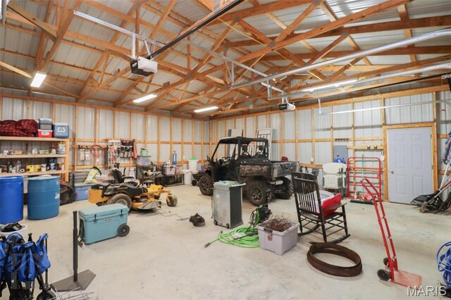 garage featuring a garage door opener and metal wall