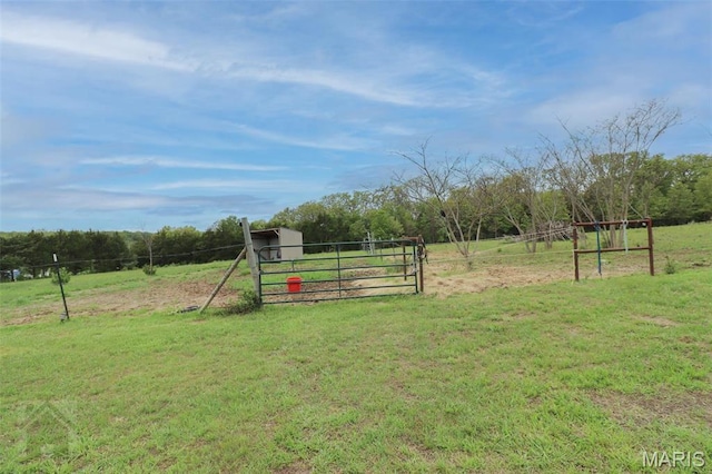 view of yard featuring a rural view and a gate