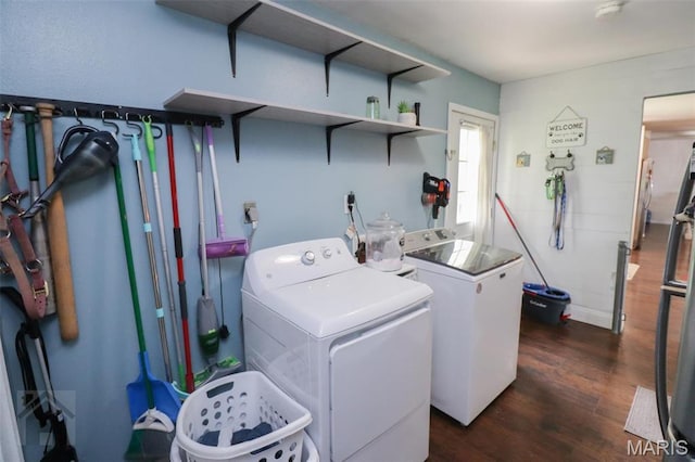washroom with washer and clothes dryer and dark wood-style floors