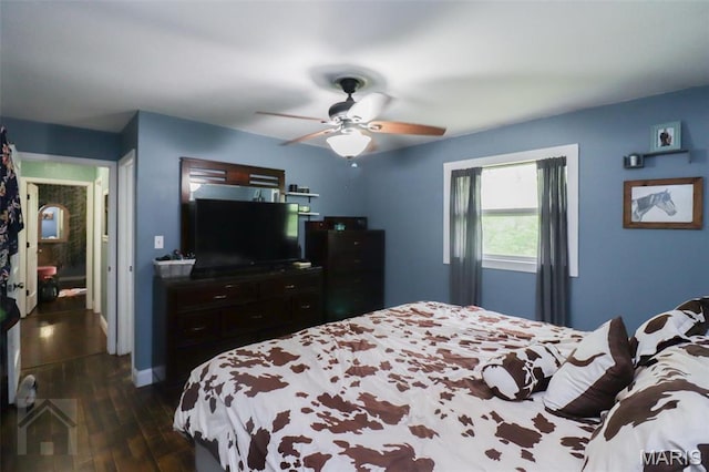bedroom featuring dark wood-style flooring, ceiling fan, and baseboards