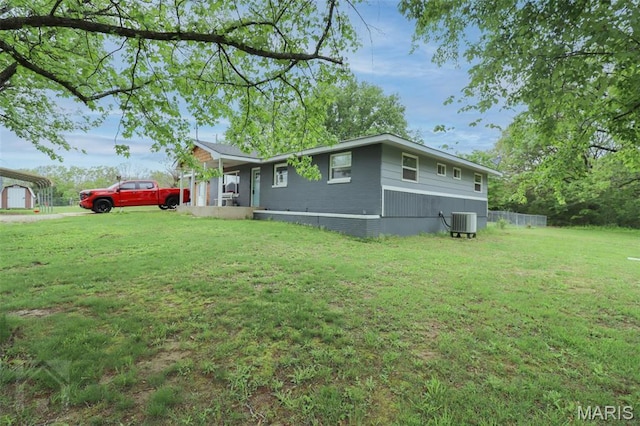view of front of house featuring central AC and a front lawn
