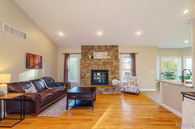 10365 Justin Cir, Rolla, MO 65401 - living room with light wood-style flooring, plenty of natural light, recessed lighting, a fireplace, and vaulted ceiling