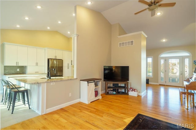 10365 Justin Cir, Rolla, MO 65401 - kitchen featuring stainless steel refrigerator with ice dispenser, a ceiling fan, light stone countertops, white cabinetry, and light wood-type flooring