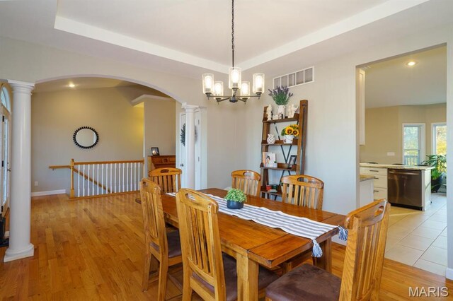 10365 Justin Cir, Rolla, MO 65401 - dining room featuring decorative columns, arched walkways, recessed lighting, a chandelier, and light wood-type flooring