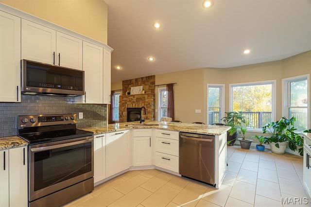 10365 Justin Cir, Rolla, MO 65401 - kitchen featuring appliances with stainless steel finishes, a peninsula, a sink, white cabinets, and recessed lighting
