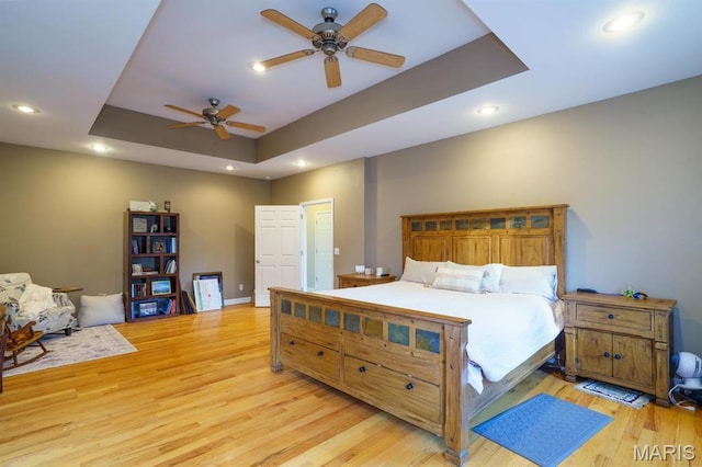 10365 Justin Cir, Rolla, MO 65401 - bedroom featuring a raised ceiling, wood finished floors, recessed lighting, a ceiling fan, and baseboards