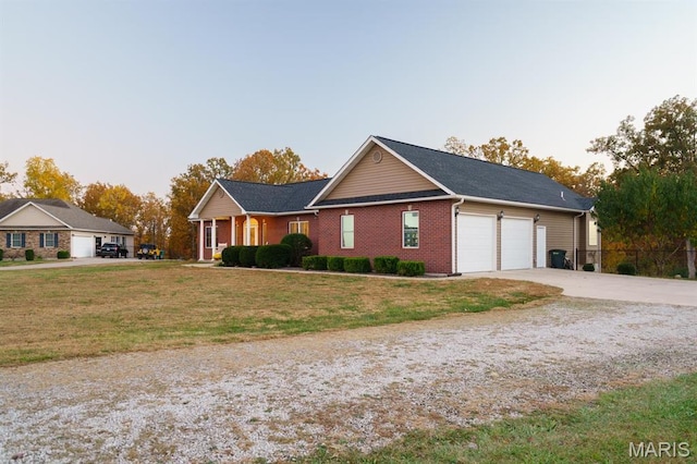 10365 Justin Cir, Rolla, MO 65401 - ranch-style home with a garage, concrete driveway, a front yard, and brick siding