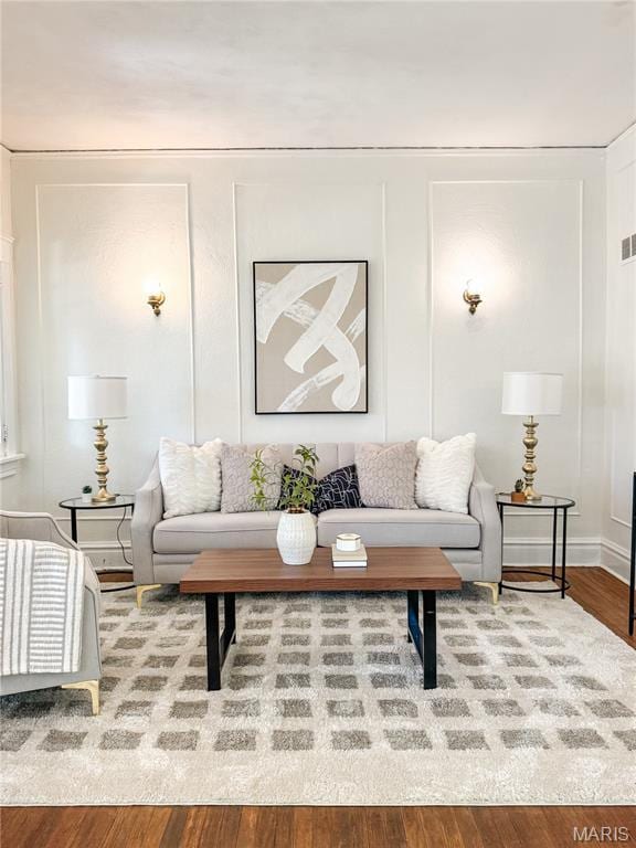 24 S Barat Ave, Saint Louis, MO 63135 - living area with wood finished floors and a decorative wall