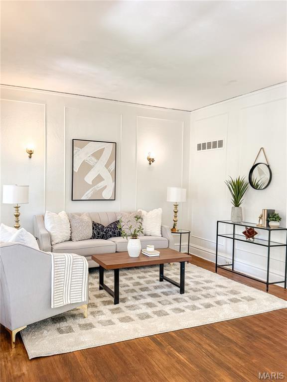 24 S Barat Ave, Saint Louis, MO 63135 - living area with wood finished floors and a decorative wall